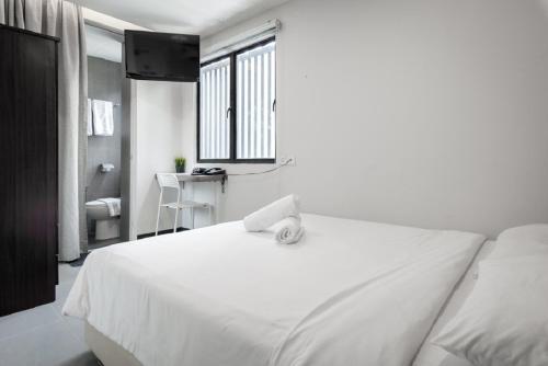 a bedroom with a white bed and a window at MAX Hotel Subang Jaya in Subang Jaya