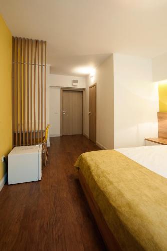 a hotel room with two beds and a table at Hotel Ceramica in Iaşi