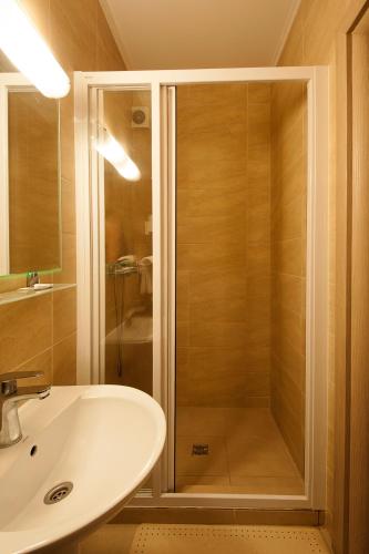 a bathroom with a shower and a sink at Hotel Ceramica in Iaşi