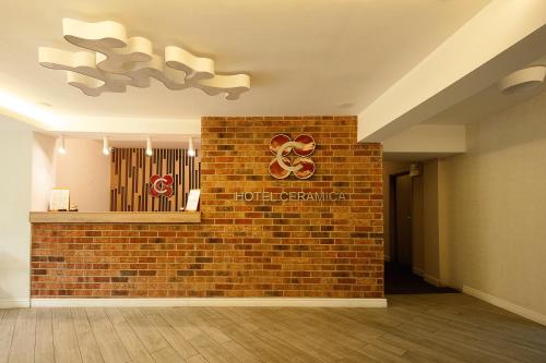 a brick wall with a sign on it at Hotel Ceramica in Iaşi