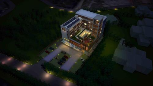 a rendering of a building at night with lights at Dmall Hotel in Kigali