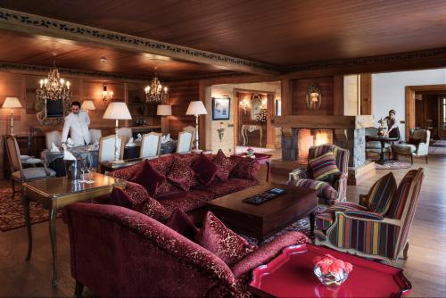 a living room with red furniture and a fireplace at Michlifen Resort & Golf in Ifrane