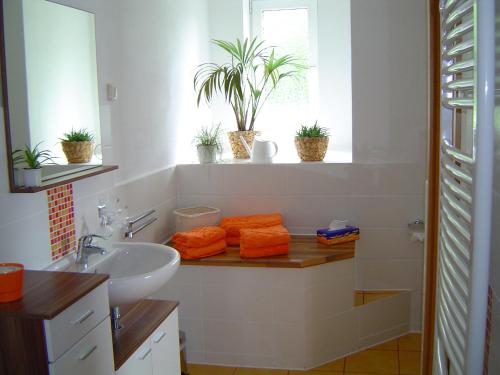 a white bathroom with a sink and a window at Ferienwohnung Fischer in Jena