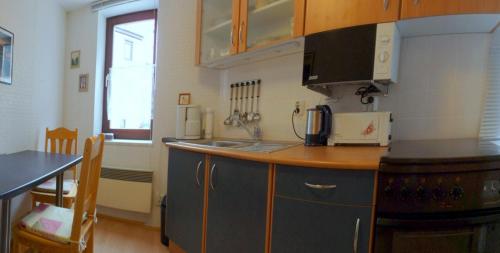 a kitchen with blue cabinets and a counter top at "Haus Saskia" in Wutha-Farnroda