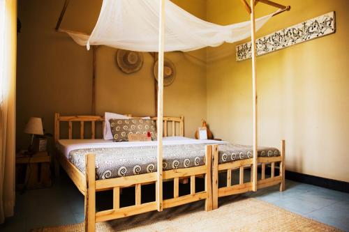 a bedroom with a bed with a canopy at More Than A Drop in Moshi