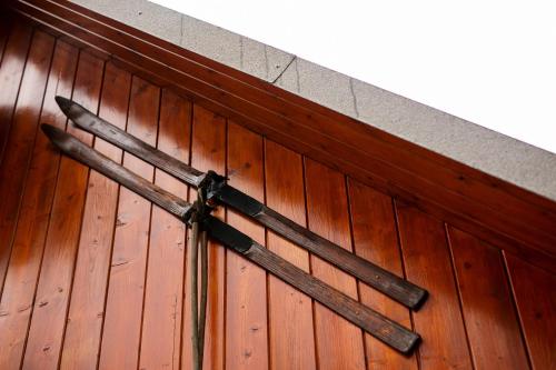 a cross on the side of a wooden wall at Cosy Chalet on Pokljuka - Brunarica Tinkara in Zgornje Gorje