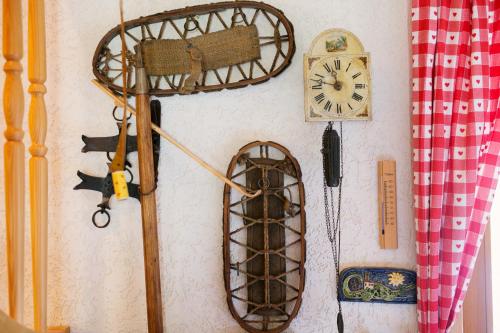 a wall with a clock and other items on it at Cosy Chalet on Pokljuka - Brunarica Tinkara in Zgornje Gorje