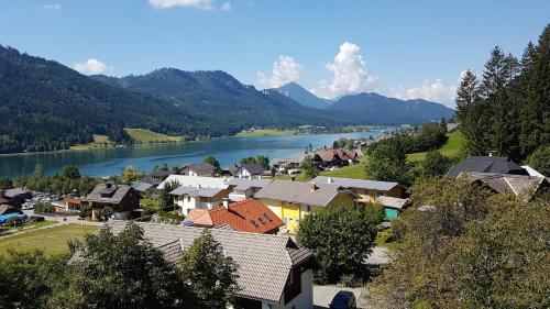 a small town with a river and a town with houses at Haus Christina in Weissensee