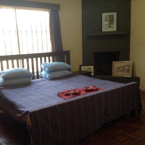 a bedroom with a bed with a red ribbon on it at Teule Guest House in Oloitokitok 