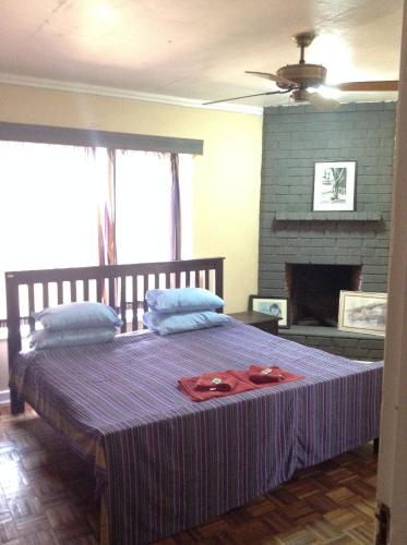 a bedroom with a purple bed with a fireplace at Teule Guest House in Oloitokitok 