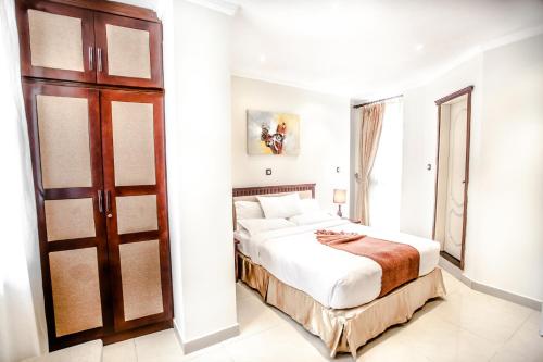 a bedroom with a bed and a sliding door at Stay Easy Hotel in Addis Ababa