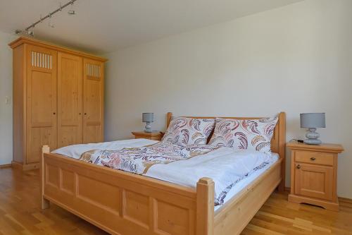 a bedroom with a bed with a wooden frame at Ferienwohnung Hentschel in Altaussee