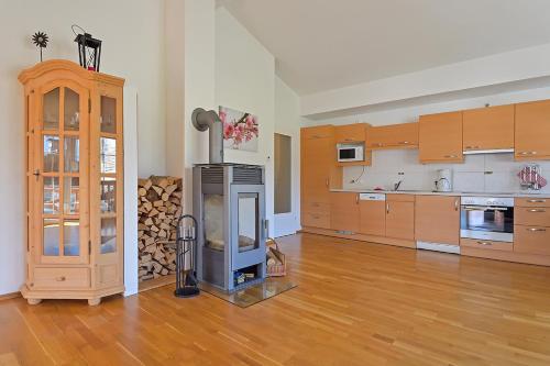 a large kitchen with a wood stove in a room at Ferienwohnung Hentschel in Altaussee