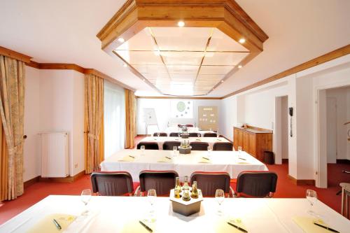 a conference room with a large white table and chairs at Vital Resort Mühl in Bad Lauterberg