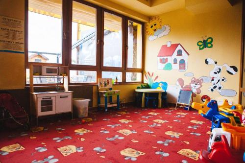 a childs room with a play area with toys on the floor at Chata 107 Tatralandia Village in Liptovský Mikuláš