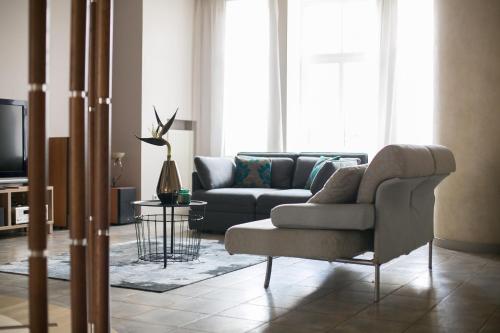 a living room with a couch and a tv at Apartment Blaumana 6 in Rīga