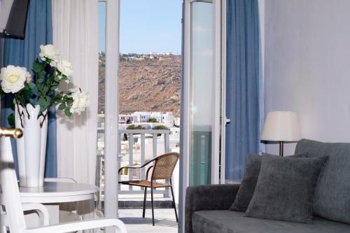 a living room with a couch and a table at Hotel Anna in Platis Yialos Mykonos