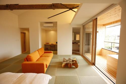 a living room with a couch and a table at Yamagata The Takinami in Nanyo
