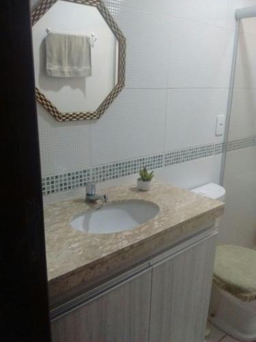 a bathroom with a sink and a mirror at Winterville Flats Gravatá in Gravatá