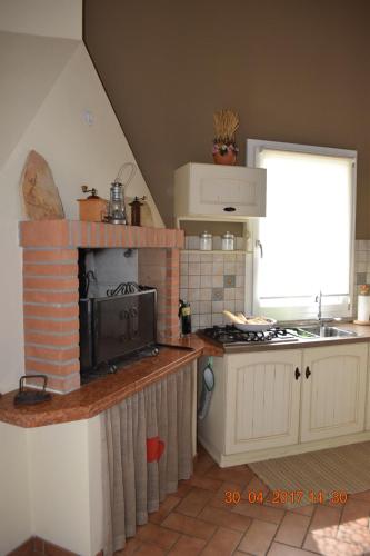 a kitchen with a stove and a stove top oven at Villa Posta Vecchia in Loreo