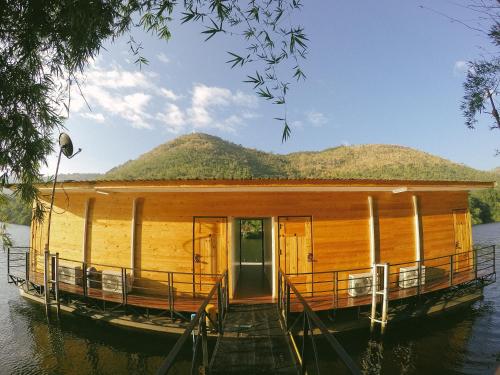 a house on a boat on the water at Baan Krupong in Ban Tha Thong Mon