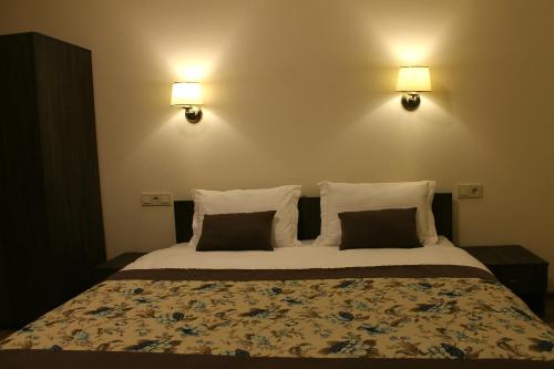 a bedroom with a large bed with two pillows at Non-stop hotel in Boryspilʼ
