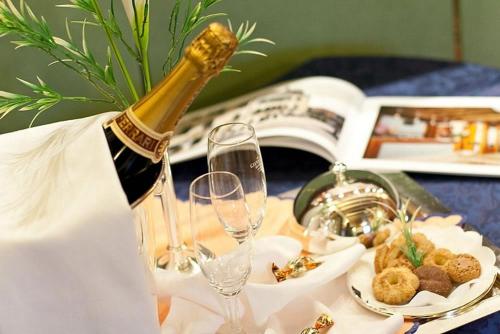 a bottle of champagne sitting on a table with glasses at Foscari Palace in Venice