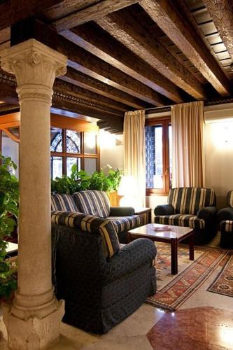 a living room with two couches and a table at Foscari Palace in Venice