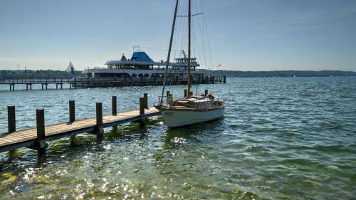 people on a boat in the water at Hotel Starnberger See in Starnberg
