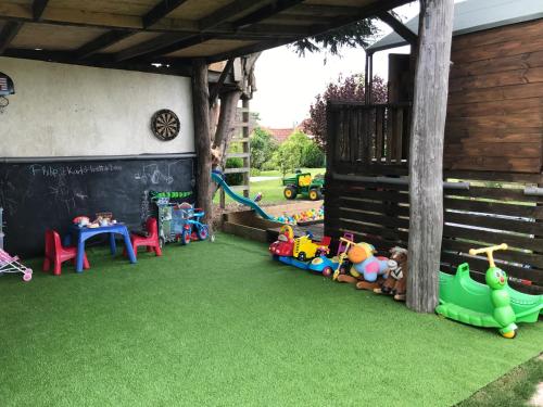 a yard with green grass and toys on it at Rew Farm Country & Equestrian Accommodation - Sunrise Lodge in Melksham
