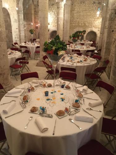 a dining room with tables with white tablecloths at Demeure des Vieux Bains in Provins