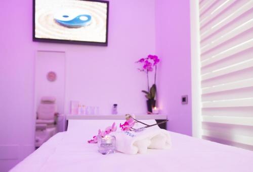 a toy figurine sitting on top of a bed at Hotel Rossini 4S in Lignano Sabbiadoro