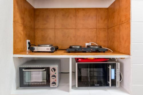 a kitchen with a microwave and a toaster oven at Hostel Seven Hills in Lisbon
