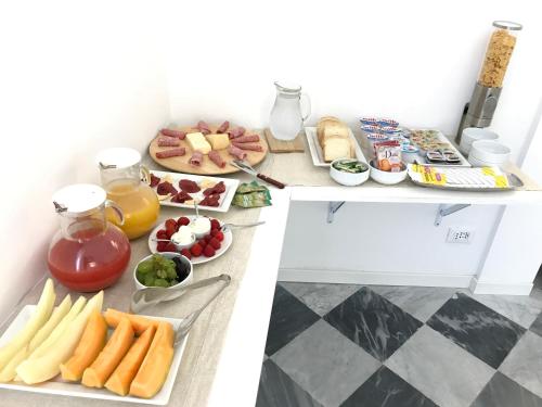 a table with breakfast foods and drinks on it at Porta Maqueda in Palermo