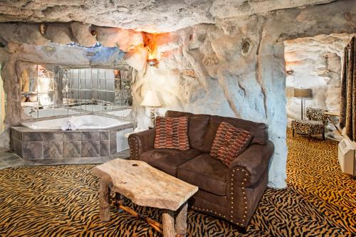 a living room with a couch and a bath tub at Days Inn & Suites by Wyndham Terre Haute in Terre Haute