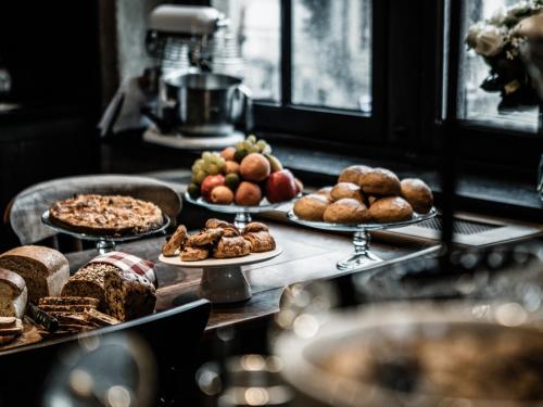 a table topped with different types of bread and pastries at 1898 The Post in Ghent