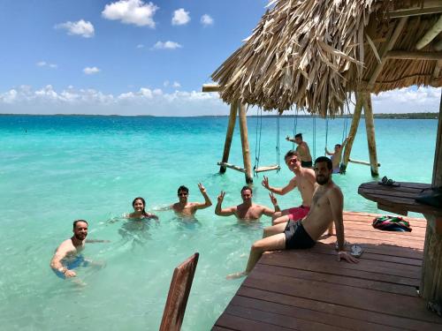 a group of people in the water in the ocean at Yaxche Centro Hostal y Camping in Bacalar
