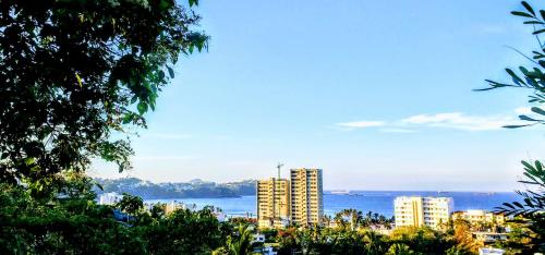 a view of a city with buildings and the water at Casa Artista in Manzanillo