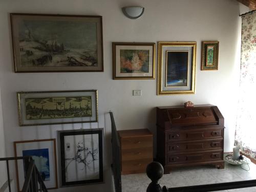 a room with a dresser and pictures on the wall at Orto dei Semplici in Farini dʼOlmo