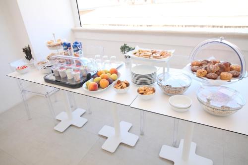 a table with a buffet of food on it at Domus Nova in Reggio Calabria