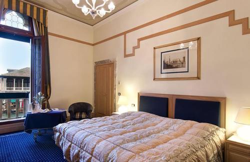 a bedroom with a large bed and a window at Foscari Palace in Venice