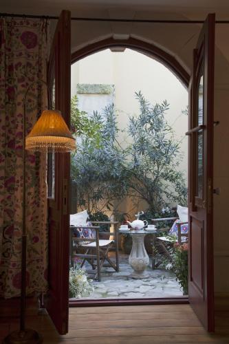 an open door to a patio with a table and a vase at Hotel Empress Zoe in Istanbul