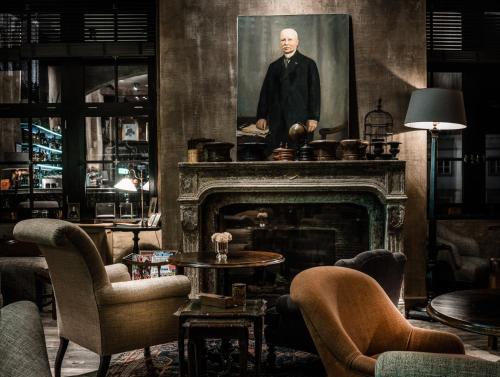 a living room with a portrait of a man on a fireplace at 1898 The Post in Ghent