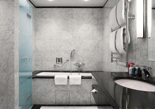 a bathroom with a sink and a bath tub at Grand Hôtel Stockholm in Stockholm