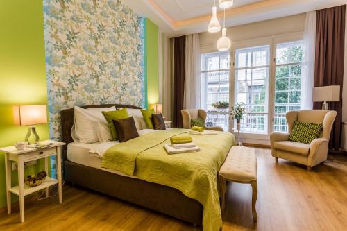 a bedroom with a large bed with a yellow bedspread at Makes You Happy Budapest in Budapest