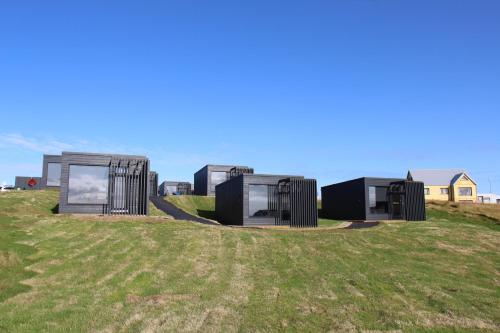 a group of modular houses on a grass field at Harbour View Cottages Grindavik in Grindavík