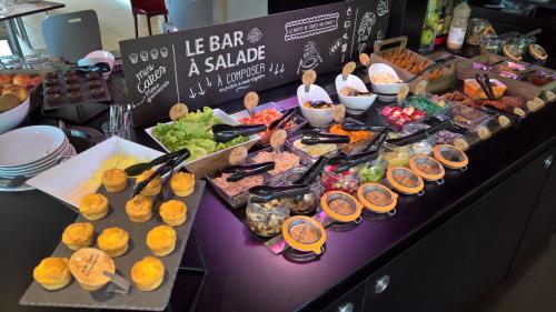 a buffet of food on a table in a store at Campanile Nevers Nord - Varennes-Vauzelles in Varennes Vauzelles