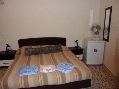a bedroom with a bed with two towels on it at San Marco in Pisa