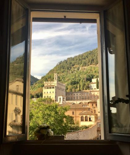 a view of a city from a window at Hotel Porta Marmorea in Gubbio