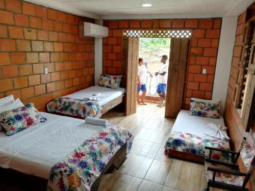 Cama o camas de una habitación en Hotel Acuali Nuqui